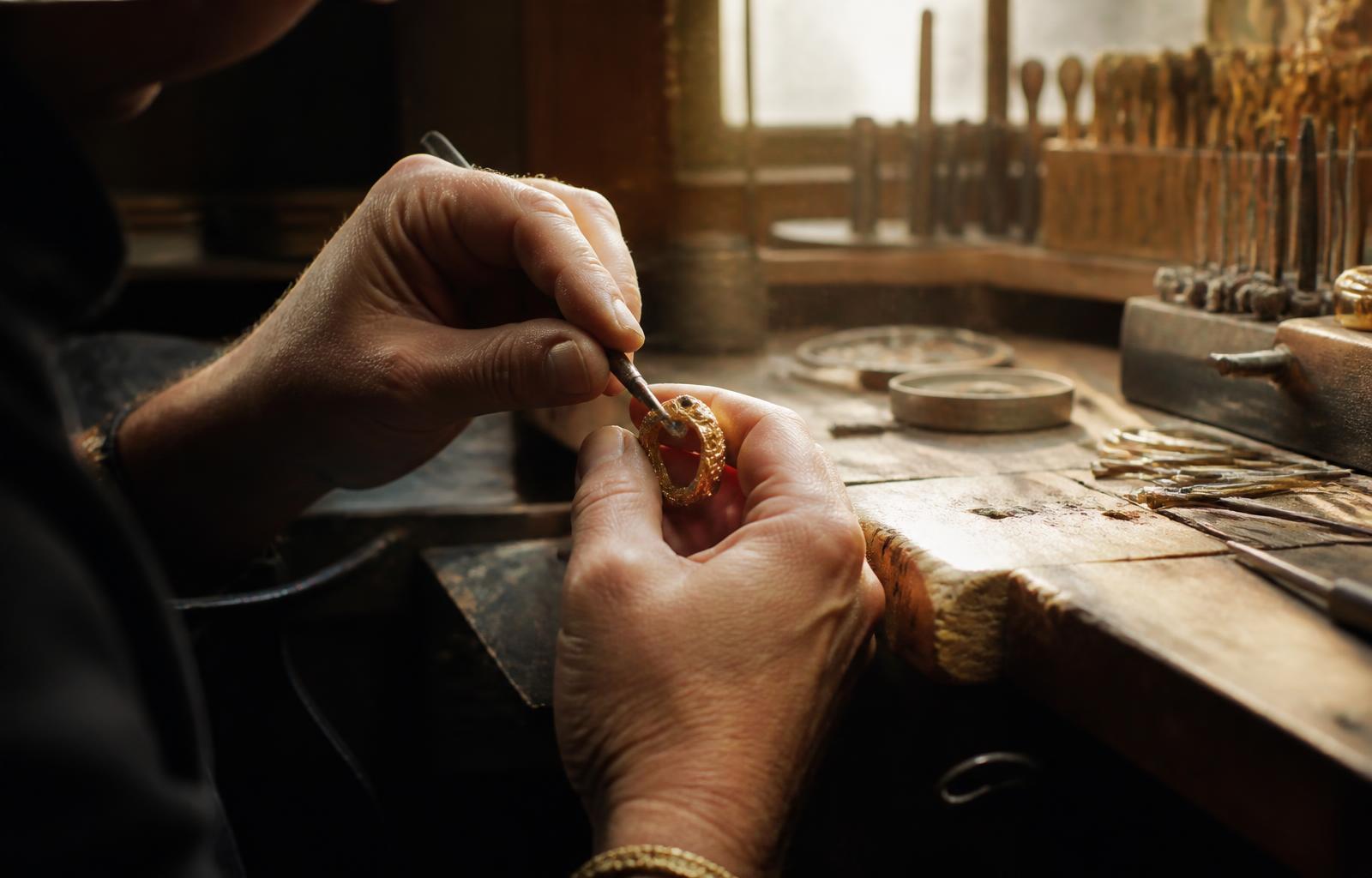 A Tensora jeweller setting a stone by hand at the bench
